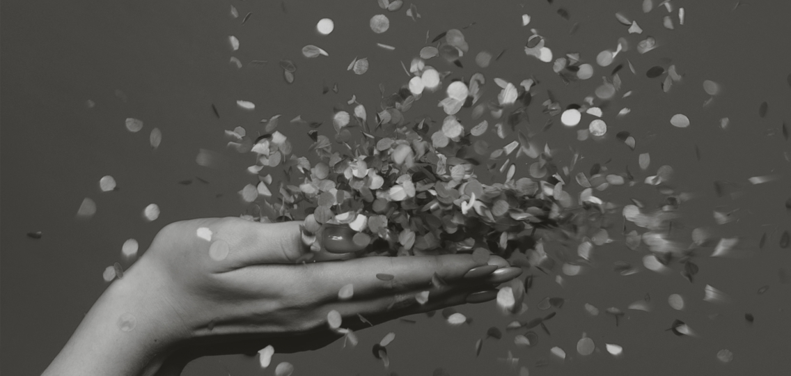 Two hands of a woman throwing confetti